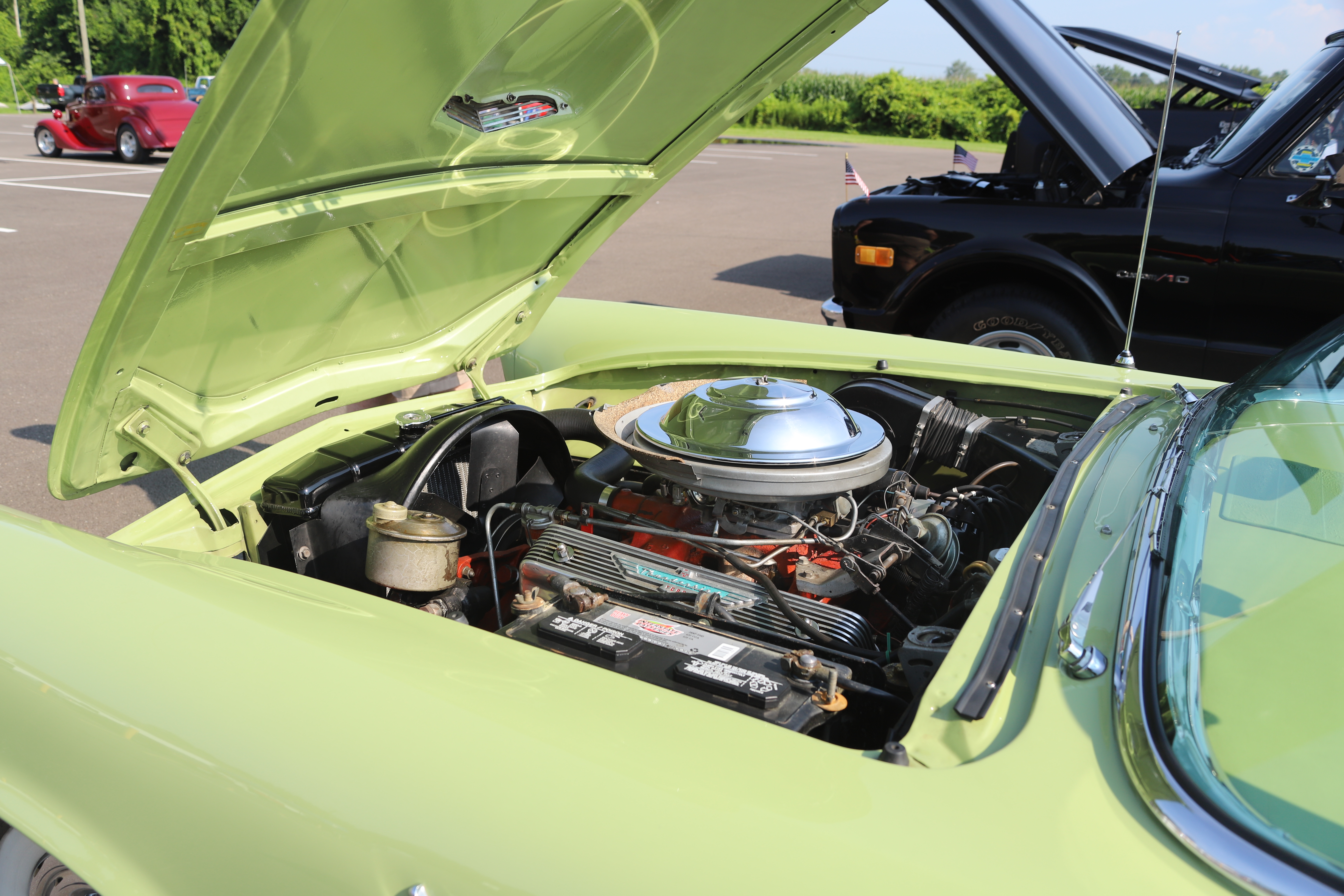 Trophy presentation ceremony at classic car show with winners receiving awards