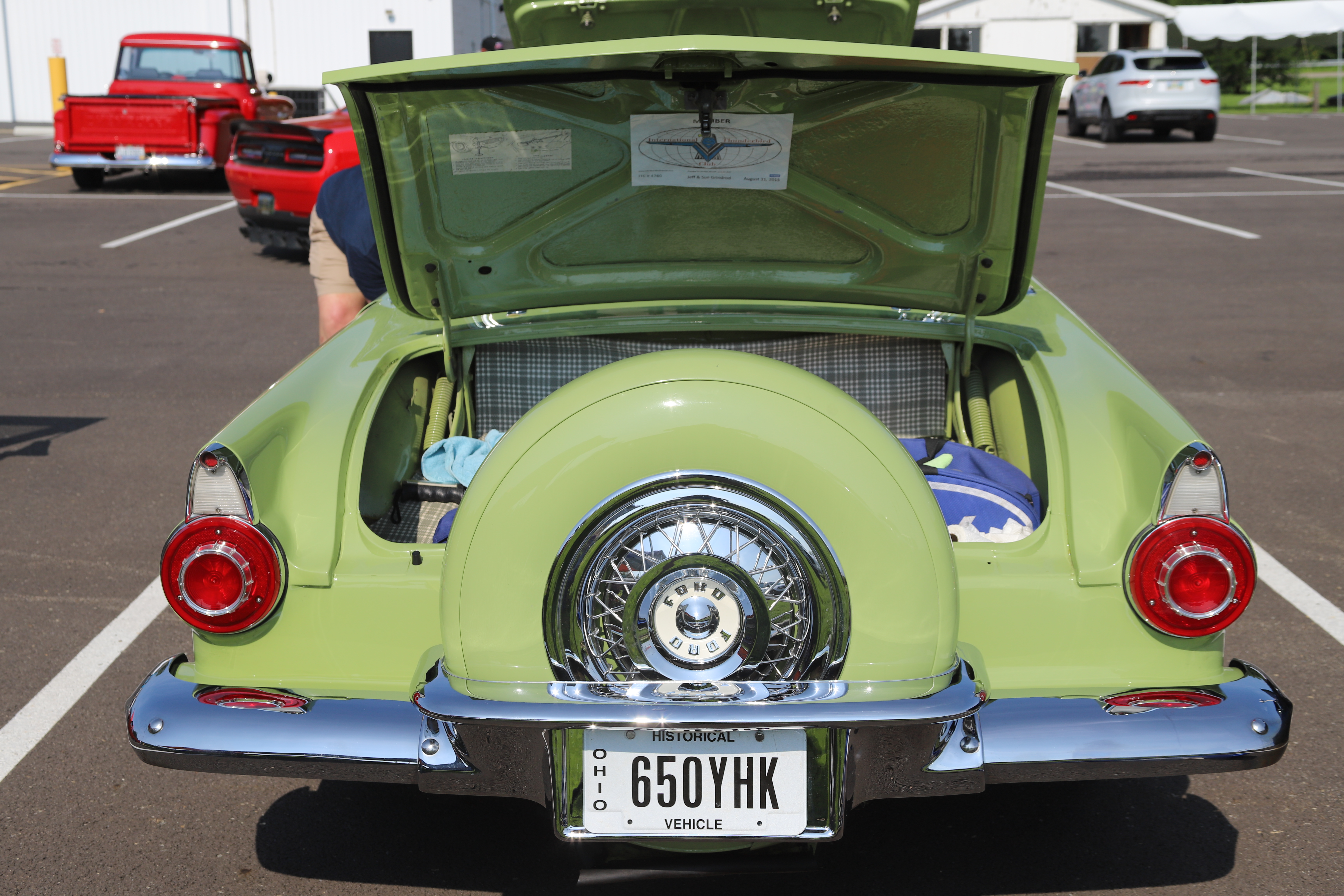Car show participants celebrating with their awards and trophies